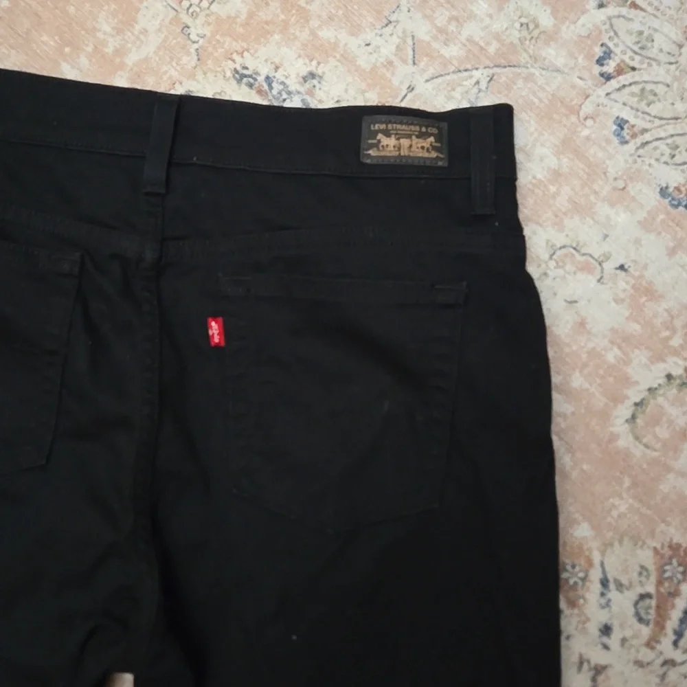 Levi's 550 relaxed boot cut Black jeans classic 5 pocket stretch 12 M Excellent…